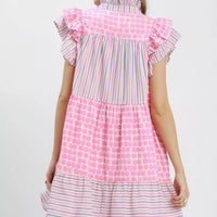 Pink tiered dress with ruffled back yoke, flutter sleeves, dot and stripe pattern