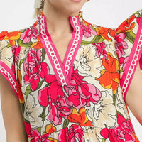 Floral V-neck midi dress bodice with pink trim and bright blossoms pattern
