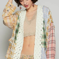 Open-front plaid cardigan with raw-edge white trim, multicolor cuffed sleeves