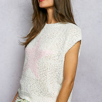 Ivory popcorn knit top with round neck and cap sleeves, pink star motif (side view)
