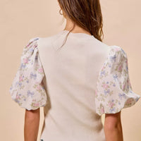 Back view: white knit sweater top with floral puff sleeves