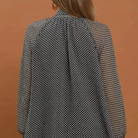 Black and white dot print tie-neck blouse, full back view with long sleeves