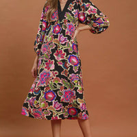 Black abstract print belted midi dress with V-neck and long puff sleeves, standing view