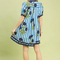Back view of blue striped short dress with navy trim and floral print