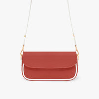 Red leather crossbody bag with front flap and white strap with gold chain