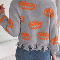Back view of gray knit V-neck sweater with orange pumpkin pattern and distressed fringe hem