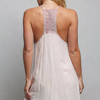 Back view of rose-pink embroidered sleeveless cotton mini dress with lace trim