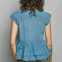 Denim blue sleeveless pintuck embroidered blouse, back view with ruffle peplum