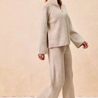 Two-tone taupe ribbed knit quarter-zip collared sweater top, walking pose