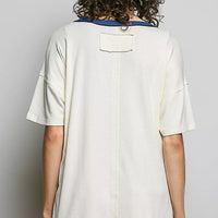 Cream cotton top back view with short sleeves and small buttoned placket