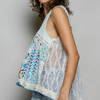Light blue sheer V-neck lace-trim tank with floral print yoke, side profile.
