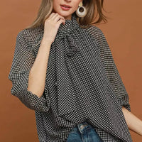 Black and white dot print tie-neck blouse with long sleeves, relaxed fit
