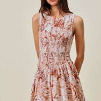 Coral and white shell print sleeveless mini dress with smocked bodice and flared skirt