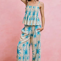 Blue palm-print smocked cami top with adjustable straps and tiered peplum front