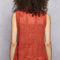 Rust orange knit sweater vest back view with buttoned upper and paneling