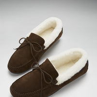 Pair of brown suede slippers with cream sheepskin lining and tied laces