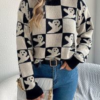 Ghost-pattern checkered round-neck sweater in black and cream, long sleeves.