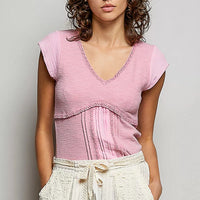 Soft pink V-neck lightweight knit top with lace-trim neckline and short sleeves