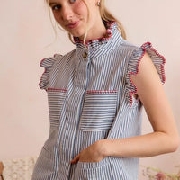 Blue and white striped sleeveless vest top with ruffled shoulders and hidden button