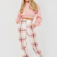 Light pink checked joggers with elastic waist and cuffed ankles.