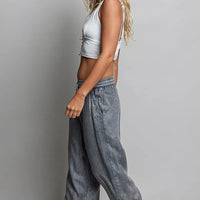 Charcoal wide-leg woven pants with elastic waist, relaxed fit, side drape
