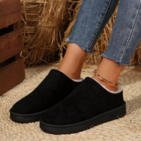 Black plush lined ankle boots with round toe, white fur trim, slip-on style.
