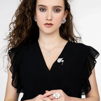Silver flower stud earrings worn with black dress, five layered petals
