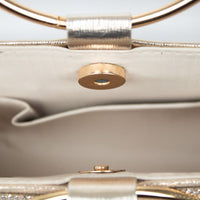 Close-up of gold double ring handle and snap clasp on clutch bag