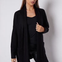 Black fringed cardigan with shawl collar and front pockets, draped open front