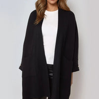 Black open-front cardigan with pearl sleeve detail and side pockets