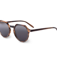 Brown tortoise-effect sunglasses with dark round lenses, side view