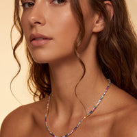 Rainbow CZ tennis necklace on model, gold chain with multicolor stones