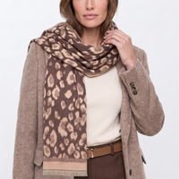 Brown spotted print scarf with fringed ends, draped over shoulders