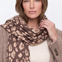 Brown spotted print scarf with fringes, loosely draped around neck