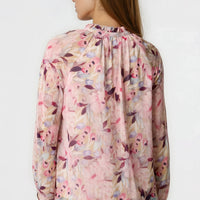 Pink floral blouse with tie neck, sheer blouson sleeves, back view