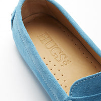 Turquoise suede loafer close-up showing perforated tan insole and stitched trim