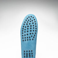 Turquoise suede loafer sole with rows of black rubber driving pods