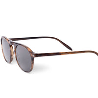 Tortoiseshell brown sunglasses, angled side view, dark lenses, green temple tips