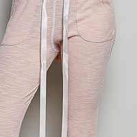 Blush pink textured knit drawstring pants with pocket detail and inner ties