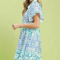 Blue floral tiered mini dress with flutter sleeves, side view