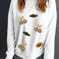 White crewneck pullover sweatshirt with sequin jack-o'-lantern and bat accents