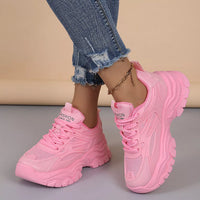 Pink chunky platform sneakers, lace-up with mesh panels and ridged chunky sole.