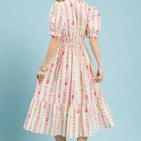 Back view cream midi dress with smocked waist, puff sleeves, tiered ruffle skirt