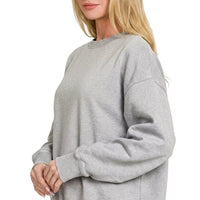 Women's gray crewneck fleece sweatshirt with relaxed long sleeves and ribbed cuffs