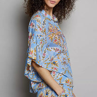 Blue floral printed woven ruffle-sleeve shirt with elastic waist, side view