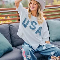 Ivory french terry top with blue "USA" appliqued letters, loose short sleeves and hem