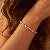 Heart tennis bracelet with oval stones on wrist, close-up