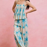 Blue palm tree adjustable cami top with smocked bodice and flared ruffle tiers