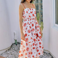 Red-and-white shell print tiered midi cami dress with belt, tiered hem, lined, spaghetti straps