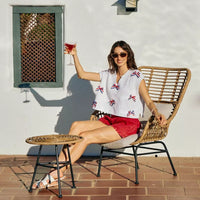 Off-white dolman sweater with red, white, and blue ribbon bow embellishments
